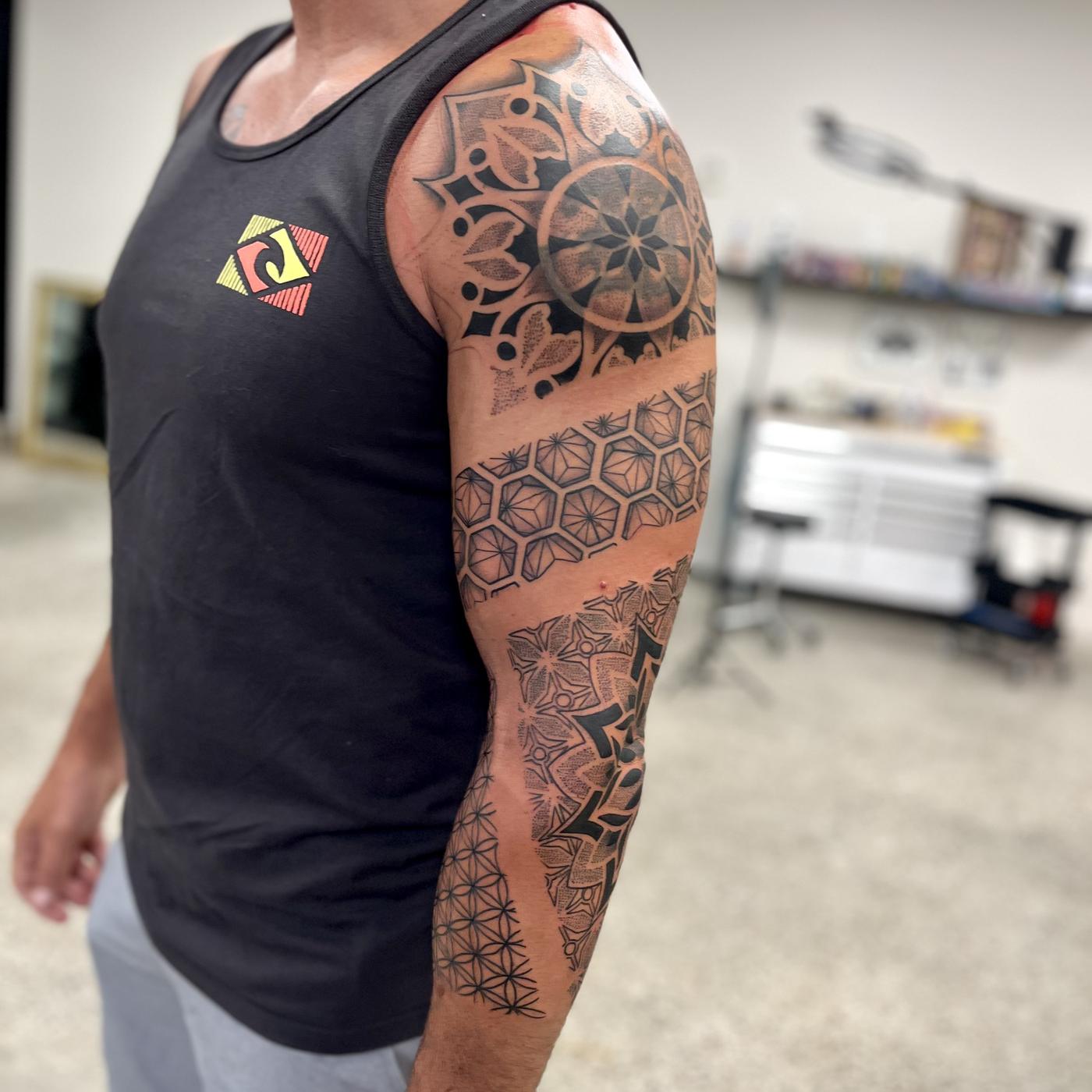 Geometric dotwork sleeve of mandalas, honeycomb and sacred geometry.